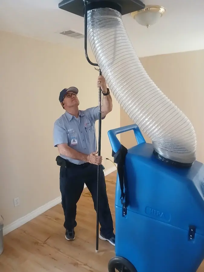 Furnace Tune-Up technician using HEPA equipment in Champlin
